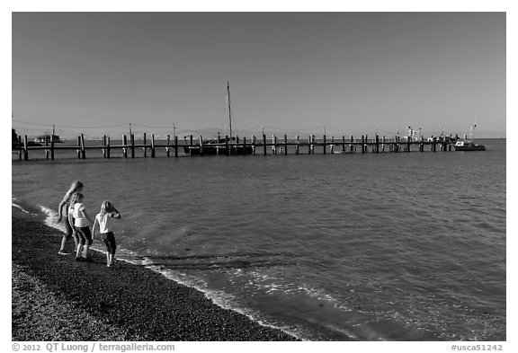 Girls on China Camp Beach near pier, China Camp State Park. San Pablo Bay, California, USA (black and white)