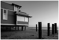 Pilings and beach house at sunset, Stinson Beach. California, USA (black and white)