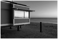 Modern beach house with large window reflecting sunset, Stinson Beach. California, USA (black and white)