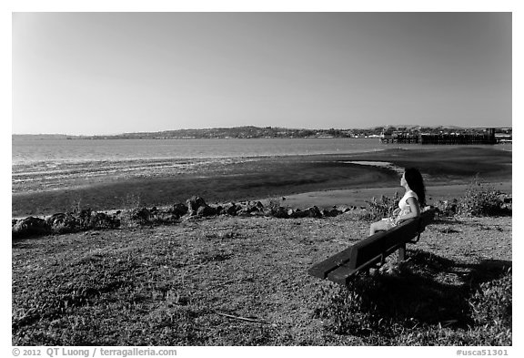 Woman sitting on bench, Carquinez Strait Regional Shoreline. Martinez, California, USA (black and white)