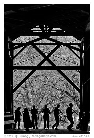 Silhouettes of people dancing inside covered bridge, Felton. California, USA