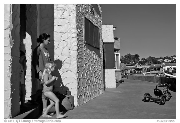 Family steps out of colorful cottage. Capitola, California, USA