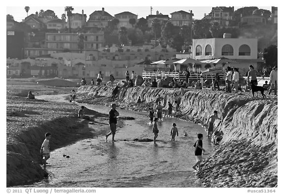 Children playing in tidal stream. Capitola, California, USA