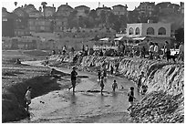 Children playing in tidal stream. Capitola, California, USA ( black and white)