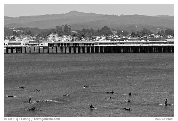 Surfers and municipal wharf. Santa Cruz, California, USA