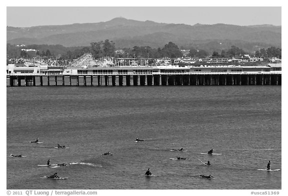 Surfers and municipal wharf. Santa Cruz, California, USA (black and white)