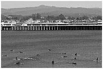 Surfers and municipal wharf. Santa Cruz, California, USA (black and white)