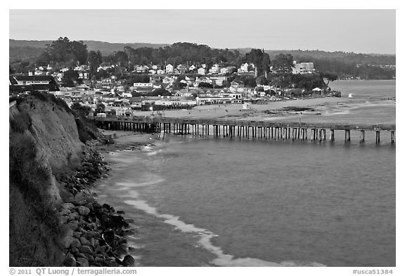 Cliff, Fishing Pier at sunset, and village. Capitola, California, USA (black and white)