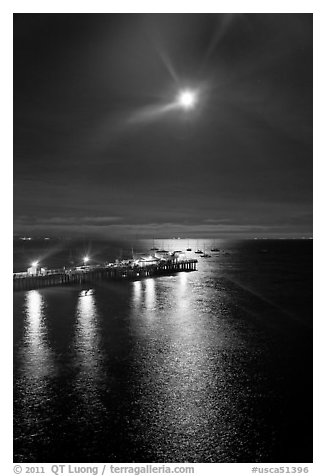 Moon and fishing pier by night. Capitola, California, USA (black and white)