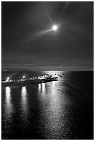 Moon and fishing pier by night. Capitola, California, USA (black and white)