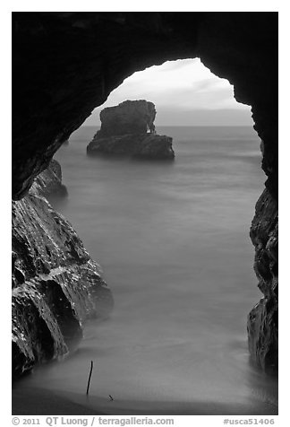 Ocean seen from sea arch at sunset, Davenport. California, USA (black and white)
