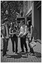 Group talking on University Avenue. Palo Alto,  California, USA (black and white)