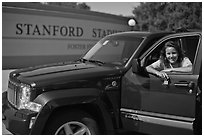 Student with new car. Stanford University, California, USA (black and white)