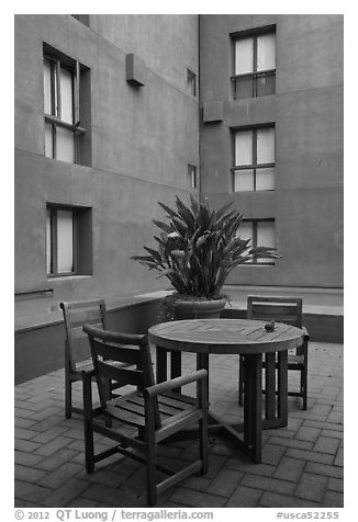 Tables and chairs in blue courtyard, Schwab Residential Center. Stanford University, California, USA (black and white)
