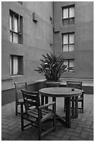 Tables and chairs in blue courtyard, Schwab Residential Center. Stanford University, California, USA (black and white)