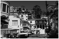 Street with hillside houses looming above, Avalon, Catalina. California, USA ( black and white)