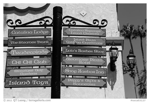 Signs pointing to local businesses, Avalon Bay, Catalina. California, USA (black and white)