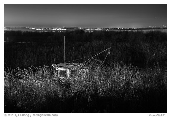 Fishing boat amongst tall grasses by night, Alviso. San Jose, California, USA