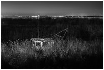 Fishing boat amongst tall grasses by night, Alviso. San Jose, California, USA (black and white)