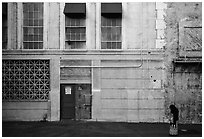 Woman standing in front of false facade, New York backlot, Paramount studios. Hollywood, Los Angeles, California, USA (black and white)