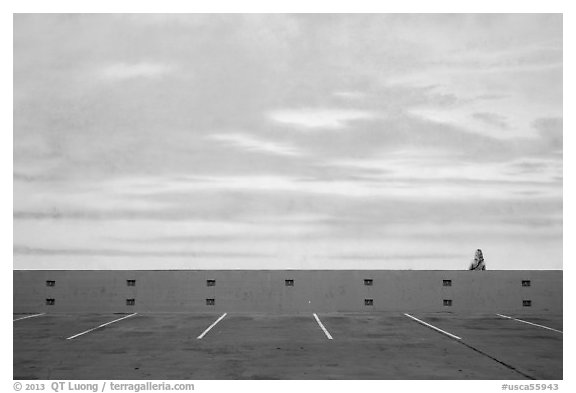 Woman looking at mural of sky and wispy clouds, Studios at Paramount. Hollywood, Los Angeles, California, USA (black and white)