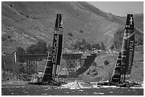 Emirates Team New Zealand leeward of Oracle Team USA at first mark. San Francisco, California, USA ( black and white)