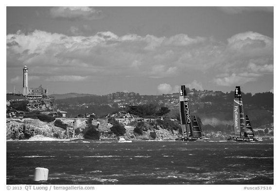 America's cup boats sail away at 40 knots from Alcatraz Island. San Francisco, California, USA (black and white)