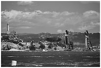 America's cup boats sail away at 40 knots from Alcatraz Island. San Francisco, California, USA ( black and white)
