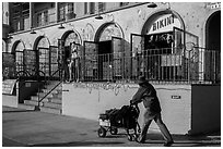 Man pushing cart in front of stores. Venice, Los Angeles, California, USA ( black and white)