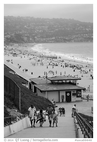 Beachgoers walking up from beach, Redondo Beach. Los Angeles, California, USA (black and white)