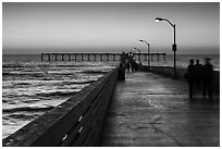 Walking on Ocean Beach Pier after sunset. San Diego, California, USA ( black and white)