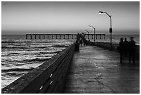 Walking on Ocean Beach Pier after sunset. San Diego, California, USA ( black and white)