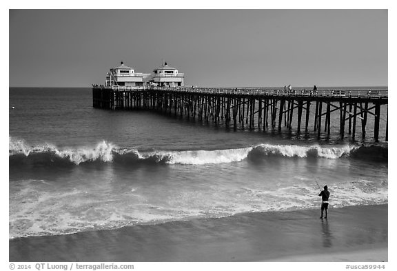 Man fishing next to Malibu Pier. Los Angeles, California, USA (black and white)