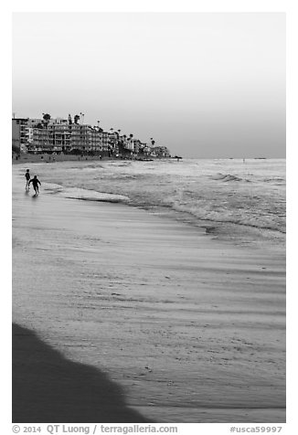 Beach at sunset with children playing. Laguna Beach, Orange County, California, USA (black and white)