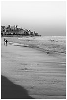 Beach at sunset with children playing. Laguna Beach, Orange County, California, USA ( black and white)