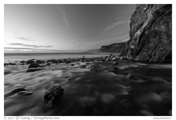 Creek, boulders, cliff, and ocean at dusk. Big Sur, California, USA (black and white)