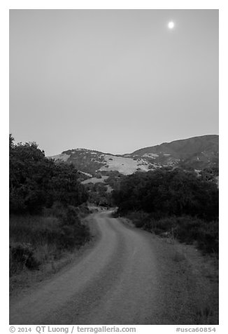 Road at dusk and moon. California, USA (black and white)