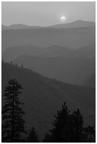Sun setting over ridges, Stanislaus National Forest. California, USA ( black and white)