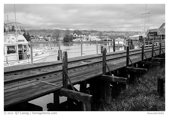 Railroad tresle and Petaluma River and Yacht Club. Petaluma, California, USA (black and white)