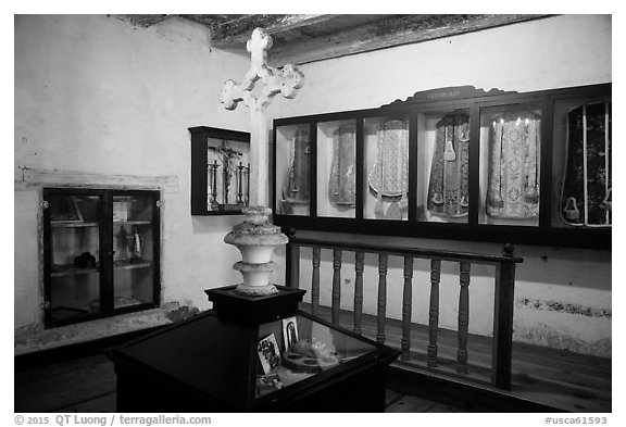 Room with cross and ceremonial dress, Mission San Juan. San Juan Bautista, California, USA (black and white)