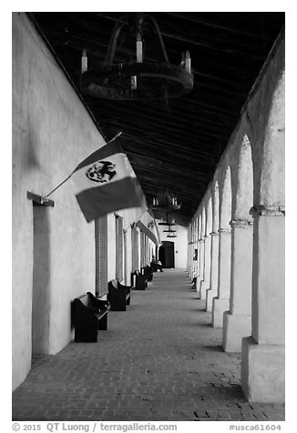 Outside arcade with Mexican and Spanish flags. California, USA (black and white)