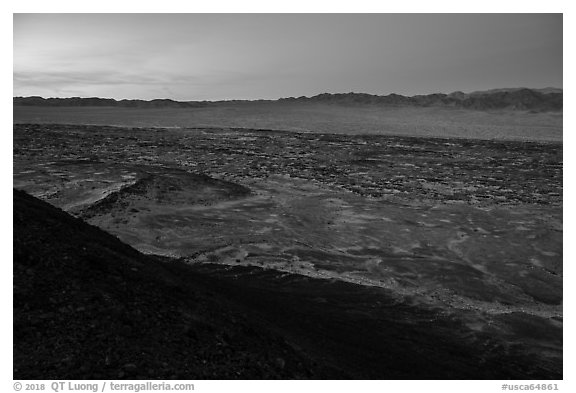 Lava field and mountains from Amboy Crater at dusk. Mojave Trails National Monument, California, USA (black and white)