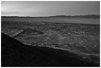 Lava field and mountains from Amboy Crater at dusk. Mojave Trails National Monument, California, USA ( black and white)