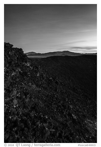 Interior slopes of Amboy Crater and mountains at dusk. Mojave Trails National Monument, California, USA (black and white)