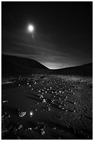 Puddle and cracked mud in Amboy Crater at night. Mojave Trails National Monument, California, USA ( black and white)