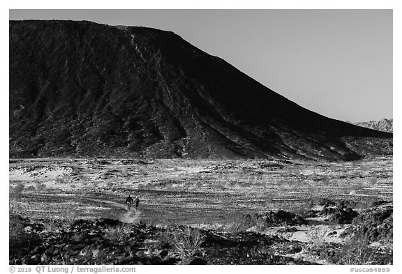 Hikers on Western Cone Trail, Amboy Crater. Mojave Trails National Monument, California, USA (black and white)