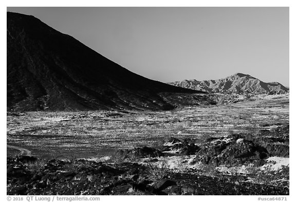 Lava field, Amboy Crater slope and mountains. Mojave Trails National Monument, California, USA (black and white)