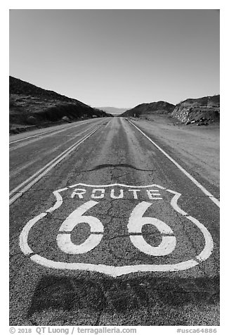 National Trails Highway (Route 66) marker and mountains. Mojave Trails National Monument, California, USA (black and white)