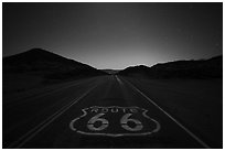 Historic Route 66 marker at night. Mojave Trails National Monument, California, USA ( black and white)