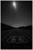 Route 66 marking and moon at night. Mojave Trails National Monument, California, USA ( black and white)